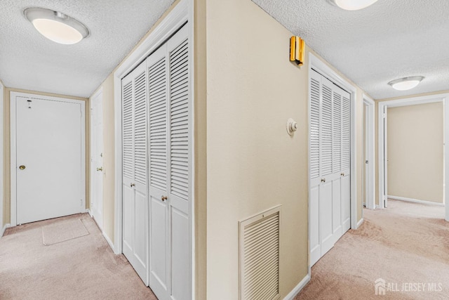 195 Mayflower Way Unit B, Monroe, NJ 08831 - hall with carpet flooring, a textured ceiling, visible vents, and baseboards