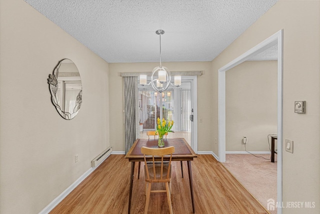 195 Mayflower Way Unit B, Monroe, NJ 08831 - dining space with a baseboard heating unit, a textured ceiling, a notable chandelier, and baseboards