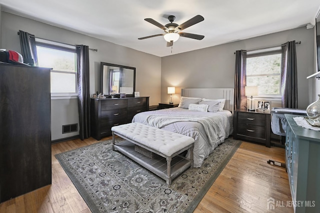 56 3rd Ave, Port Reading, NJ 07064 - bedroom with multiple windows, light wood-style flooring, and ceiling fan