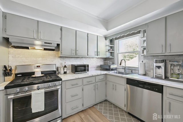 56 3rd Ave, Port Reading, NJ 07064 - kitchen featuring appliances with stainless steel finishes, under cabinet range hood, gray cabinetry, ornamental molding, and open shelves