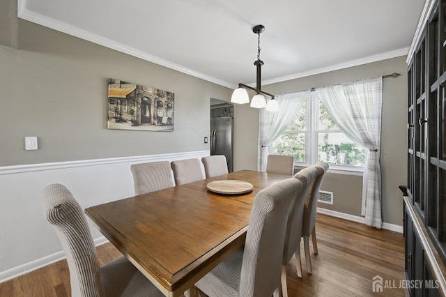 56 3rd Ave, Port Reading, NJ 07064 - dining space with ornamental molding and dark wood-type flooring