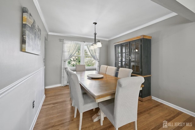 56 3rd Ave, Port Reading, NJ 07064 - dining area featuring a chandelier, wood finished floors, and crown molding