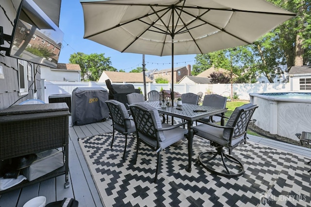 56 3rd Ave, Port Reading, NJ 07064 - wooden deck with outdoor dining area, a fenced backyard, and a grill
