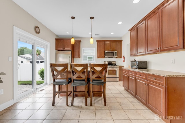 51 N Smith St, Avenel, NJ 07001 - kitchen featuring appliances with stainless steel finishes, light tile patterned floors, brown cabinetry, hanging light fixtures, and recessed lighting