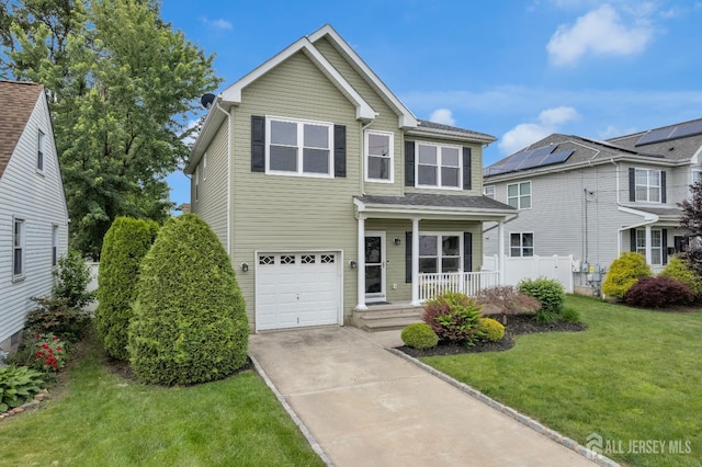 51 N Smith St, Avenel, NJ 07001 - traditional home featuring a porch, driveway, a front lawn, and a garage