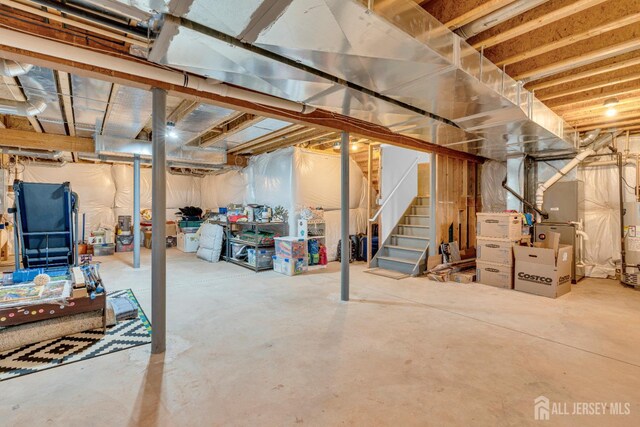 51 N Smith St, Avenel, NJ 07001 - unfinished below grade area with stairs, heating unit, and gas water heater