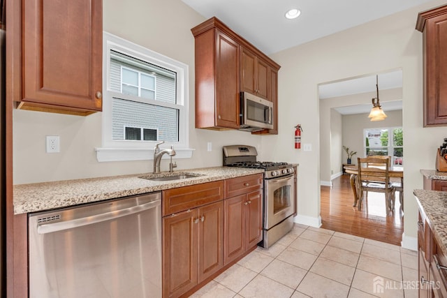 51 N Smith St, Avenel, NJ 07001 - kitchen featuring appliances with stainless steel finishes, light tile patterned flooring, light stone countertops, recessed lighting, and brown cabinetry