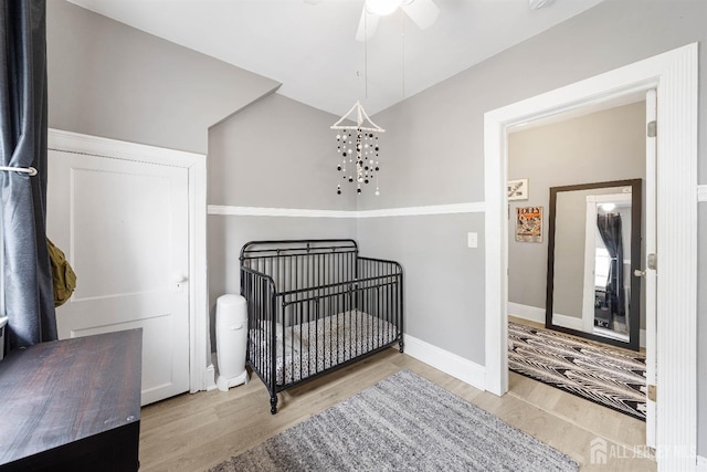 1402 Glenwood Dr, Piscataway, NJ 08854 - bedroom featuring wood finished floors, a nursery area, lofted ceiling, a ceiling fan, and baseboards