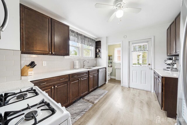 1402 Glenwood Dr, Piscataway, NJ 08854 - kitchen featuring dishwasher, white range with gas stovetop, light wood-style flooring, ceiling fan, and dark brown cabinets