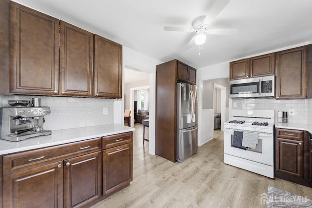 1402 Glenwood Dr, Piscataway, NJ 08854 - kitchen featuring stainless steel appliances, a ceiling fan, light countertops, light wood-style floors, and dark brown cabinetry