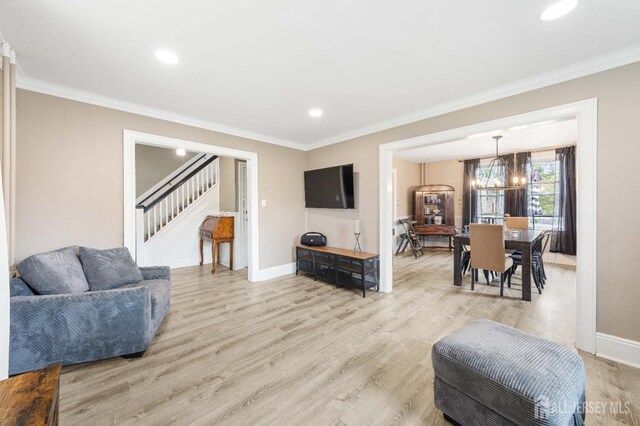 1402 Glenwood Dr, Piscataway, NJ 08854 - living room with stairway, ornamental molding, light wood finished floors, baseboards, and a chandelier