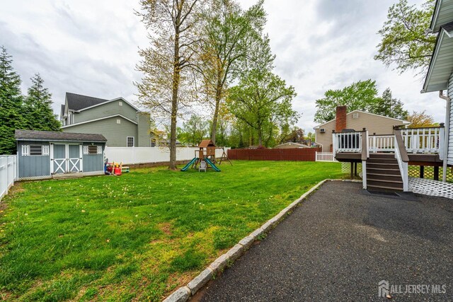 1402 Glenwood Dr, Piscataway, NJ 08854 - view of yard with a playground, a deck, a shed, an outdoor structure, and stairs