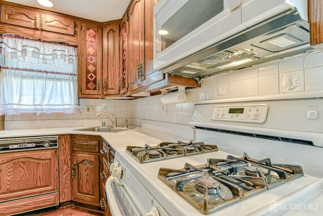 79 S Hill Rd, Colonia, NJ 07067 - kitchen featuring white appliances, brown cabinets, a sink, light countertops, and decorative backsplash
