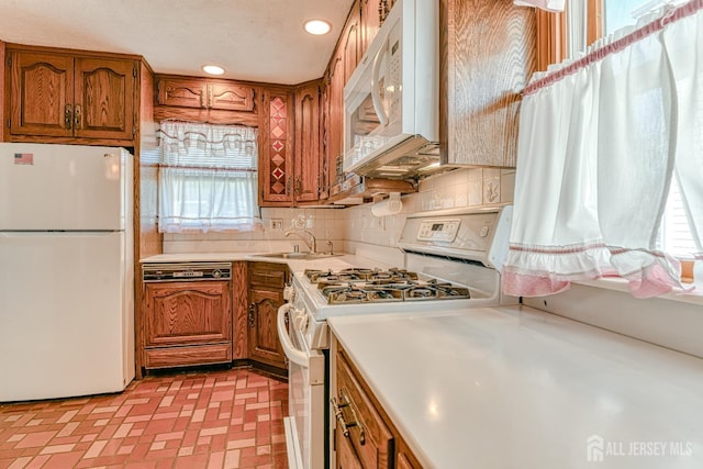 79 S Hill Rd, Colonia, NJ 07067 - kitchen featuring white appliances, brown cabinetry, light countertops, a sink, and recessed lighting