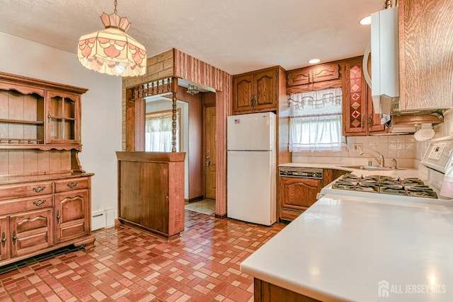 79 S Hill Rd, Colonia, NJ 07067 - kitchen with white appliances, a baseboard heating unit, backsplash, brown cabinets, and decorative light fixtures