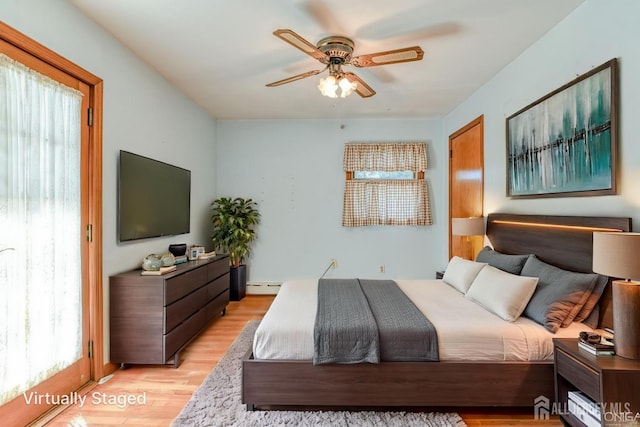 79 S Hill Rd, Colonia, NJ 07067 - bedroom featuring a baseboard radiator, multiple windows, light wood-style floors, and a ceiling fan