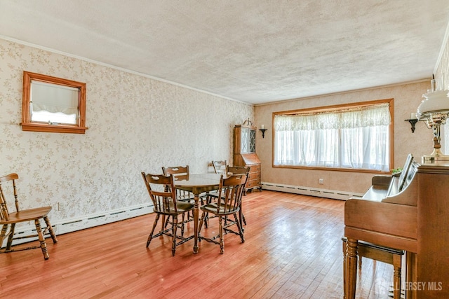 79 S Hill Rd, Colonia, NJ 07067 - dining space with a baseboard heating unit, hardwood / wood-style flooring, wallpapered walls, ornamental molding, and a textured ceiling