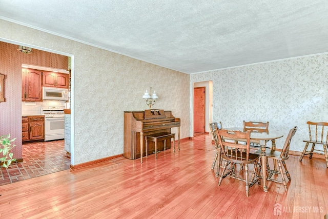 79 S Hill Rd, Colonia, NJ 07067 - dining room featuring crown molding, light wood-type flooring, a textured ceiling, and wallpapered walls