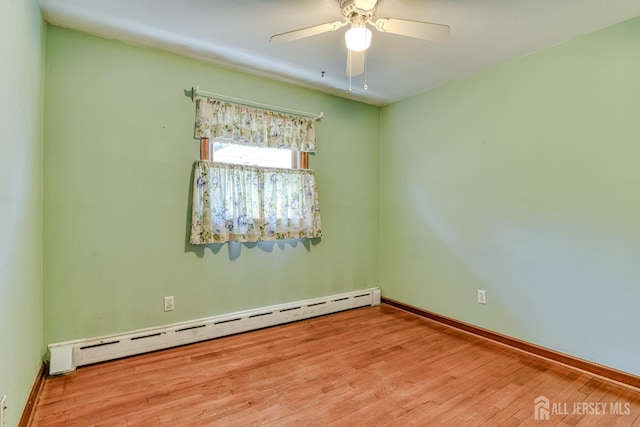 79 S Hill Rd, Colonia, NJ 07067 - unfurnished room featuring a baseboard heating unit, wood finished floors, a ceiling fan, and baseboards