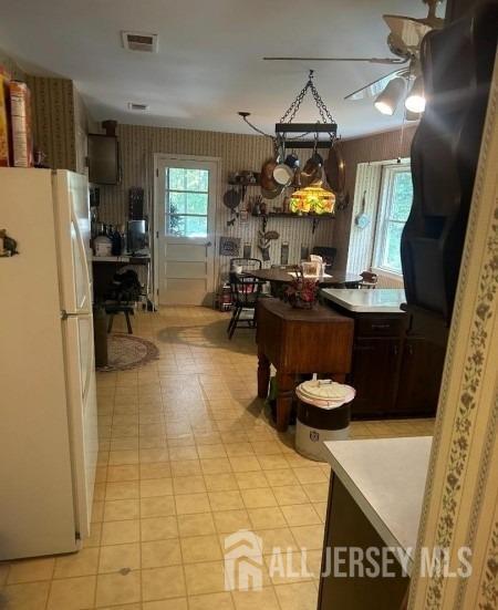 188 N Rd, Chester Twp, NJ 07930 - kitchen with freestanding refrigerator, a ceiling fan, and light floors