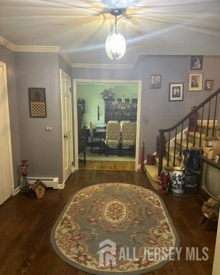188 N Rd, Chester Twp, NJ 07930 - foyer with a baseboard radiator, wood finished floors, stairway, and a chandelier