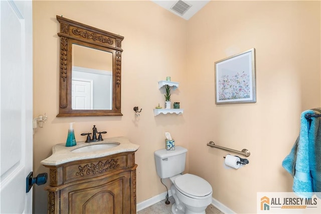 bathroom featuring tile patterned flooring, vanity, and toilet