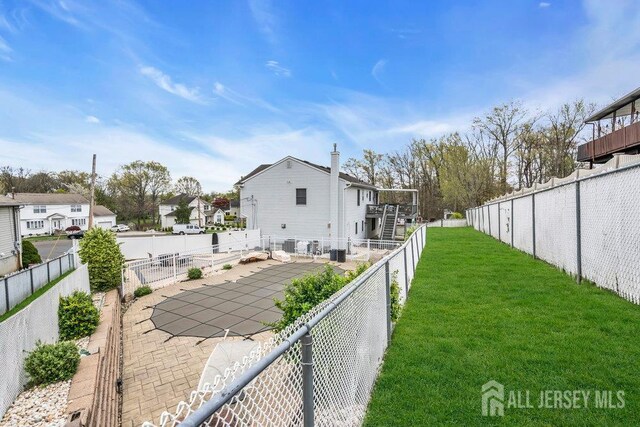 6 Muravski Ct, South River, NJ 08882 - back of property featuring a residential view, a fenced backyard, and a patio
