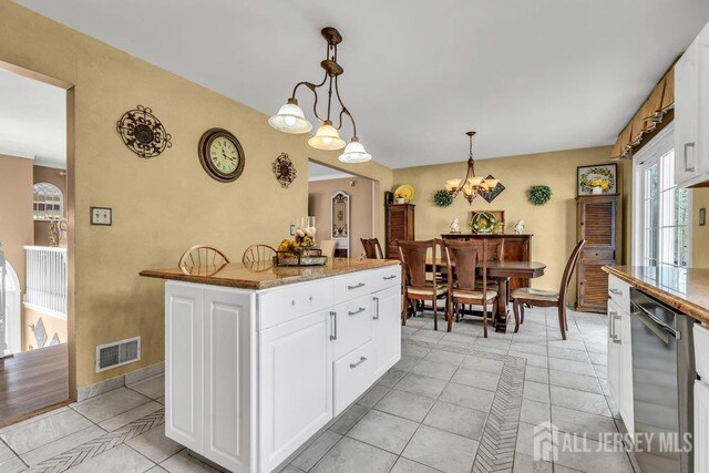 6 Muravski Ct, South River, NJ 08882 - kitchen featuring dishwasher, white cabinets, hanging light fixtures, light tile patterned flooring, and a chandelier