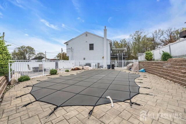 6 Muravski Ct, South River, NJ 08882 - rear view of house featuring a fenced backyard, a patio, and a chimney