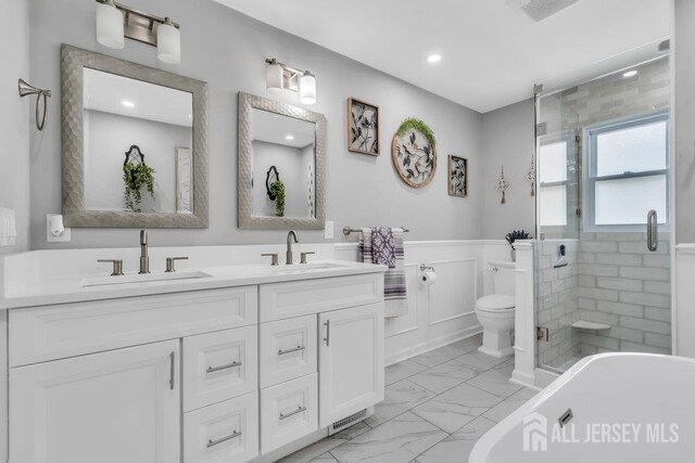 6 Muravski Ct, South River, NJ 08882 - full bathroom featuring marble finish floors, double vanity, a soaking tub, wainscoting, and a stall shower