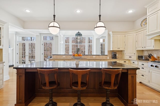 56 Cradle Rock Rd, Princeton, NJ 08540 - kitchen featuring decorative backsplash, a kitchen island, a kitchen breakfast bar, recessed lighting, and light wood-style flooring