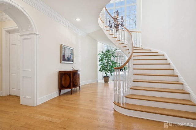 56 Cradle Rock Rd, Princeton, NJ 08540 - staircase with wood finished floors, a chandelier, recessed lighting, arched walkways, and ornamental molding