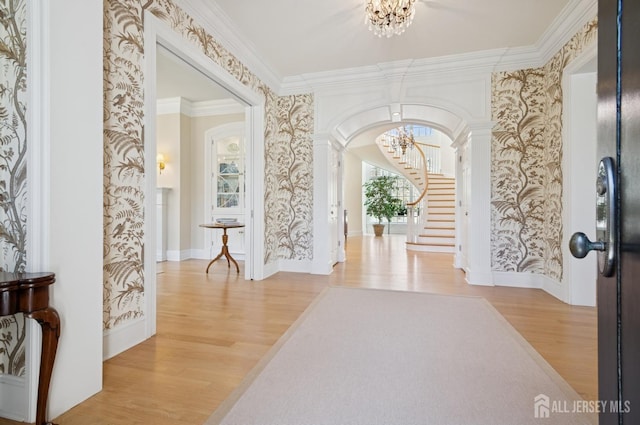 56 Cradle Rock Rd, Princeton, NJ 08540 - foyer entrance featuring a chandelier, stairs, wood finished floors, wallpapered walls, and ornate columns