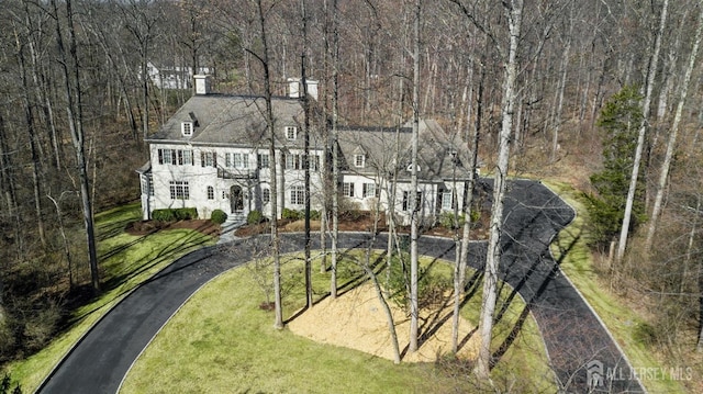 56 Cradle Rock Rd, Princeton, NJ 08540 - view of front of house featuring a chimney, a front lawn, and asphalt driveway
