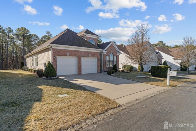 view of front of home with a garage and a front lawn