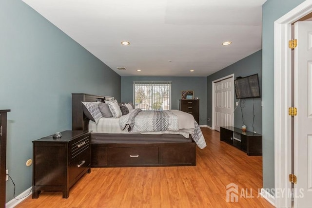 bedroom with recessed lighting, visible vents, baseboards, and light wood-style floors