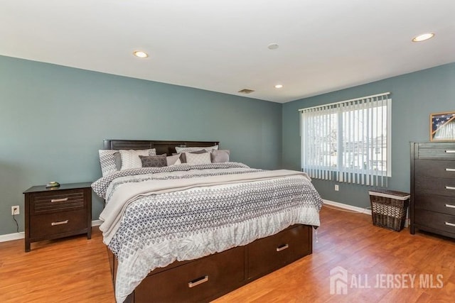 bedroom featuring recessed lighting, wood finished floors, visible vents, and baseboards