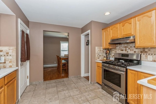 kitchen with a baseboard heating unit, light countertops, stainless steel range with gas stovetop, and under cabinet range hood