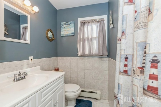 bathroom featuring tile walls, a baseboard heating unit, toilet, tile patterned floors, and vanity