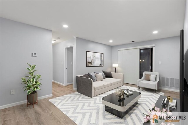 living room with light hardwood / wood-style flooring