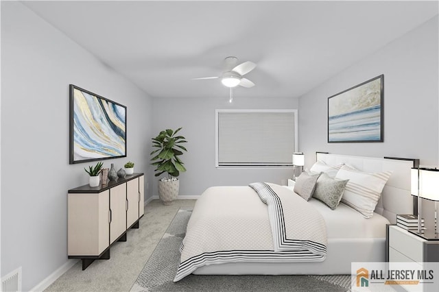 bedroom with ceiling fan and light colored carpet