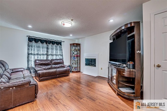 32 Prestwick Way Unit 32, Edison, NJ 08820 - living area featuring wood finished floors, a textured ceiling, and recessed lighting