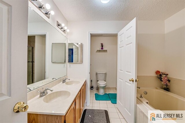 32 Prestwick Way Unit 32, Edison, NJ 08820 - full bath with tile patterned floors, a garden tub, double vanity, and a textured ceiling