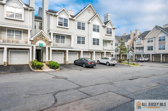 32 Prestwick Way Unit 32, Edison, NJ 08820 - view of property featuring a residential view, stone siding, and a chimney