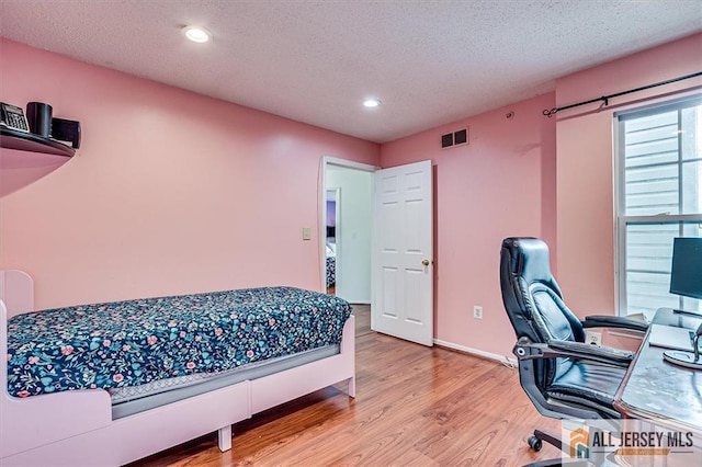 32 Prestwick Way Unit 32, Edison, NJ 08820 - bedroom with wood finished floors, recessed lighting, a textured ceiling, and an office area