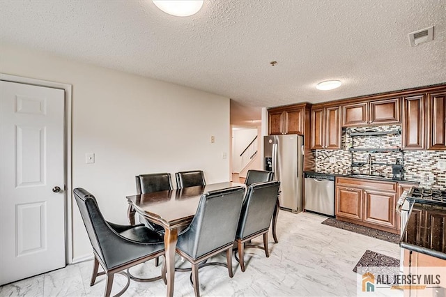 32 Prestwick Way Unit 32, Edison, NJ 08820 - dining area with light marble finish flooring, wet bar, a textured ceiling, and stairs