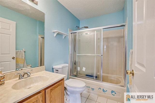 32 Prestwick Way Unit 32, Edison, NJ 08820 - full bathroom featuring vanity, a textured ceiling, tile patterned floors, and shower / bath combination with glass door