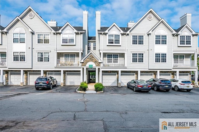 32 Prestwick Way Unit 32, Edison, NJ 08820 - view of property featuring a chimney and stone siding