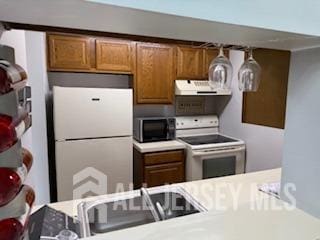 2112 Ravens Crest Dr, Plainsboro, NJ 08536 - kitchen with brown cabinetry, freestanding refrigerator, electric range, range hood, and light countertops