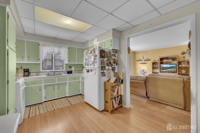 28 Lehigh St, Dunellen, NJ 08812 - kitchen with green cabinetry, white appliances, light wood-style floors, a drop ceiling, and light countertops